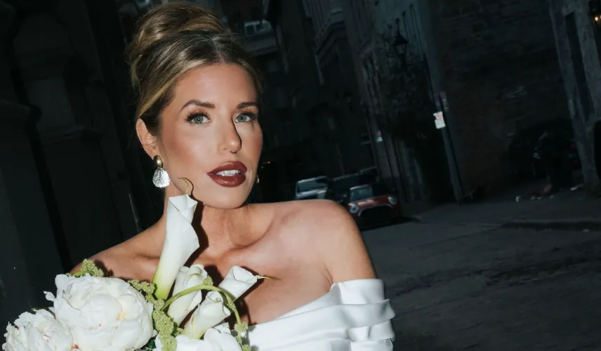 Wedding & Bridal Makeup by Waring Makeup - Ottawa Bridal Makeup Artist Bride with bold makeup holding a bouquet of calla lilies, styled by Waring Makeup, photographed in a downtown setting in Ottawa.