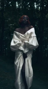 Bride in a satin gown with dramatic bridal makeup in a forest setting by Waring Makeup, Ottawa Wedding Makeup Artist.