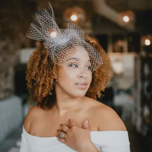 Testimonial by Kashani T Elegant bride with a curly hairstyle and a birdcage veil, styled by Waring Makeup, Ottawa Bridal Makeup Artist.