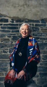 Smiling executive woman in a colorful scarf with polished corporate makeup, styled by Waring Makeup, Ottawa Corporate Makeup Artist.