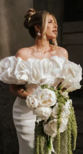 Modern bride in off-shoulder gown holding bouquet with bold makeup by Waring Makeup, Ottawa Wedding Makeup Artist.