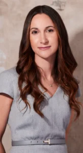 Professional woman in a grey business dress with corporate makeup, styled by Waring Makeup, Ottawa Office Makeup Services.