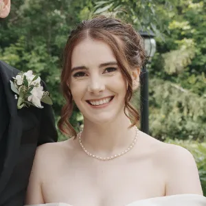 Testimonial by Eve G Smiling bride with elegant bridal makeup, styled by Waring Makeup, Ottawa Bridal Makeup Artist, featured alongside a testimonial.