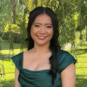 Testimonial by Freshzelyn R Smiling bridesmaid with elegant makeup in an outdoor setting, styled by Waring Makeup, Ottawa Bridal Makeup Artist.