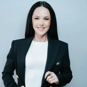 Smiling woman in a black blazer with professional makeup, styled by Waring Makeup, Corporate Makeup Artist Ottawa.